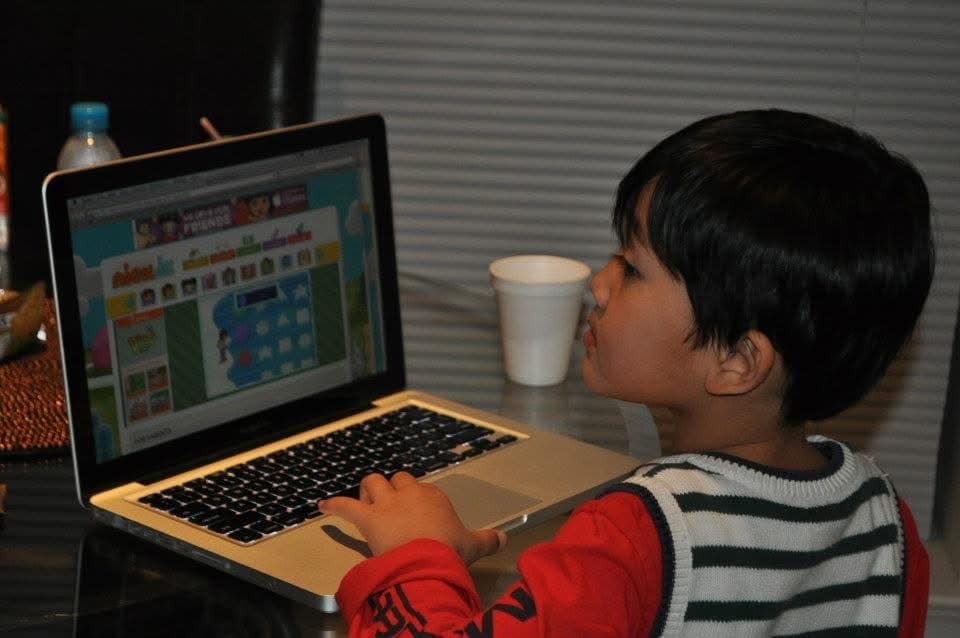 Ihsan Tjahyono as a child at a laptop