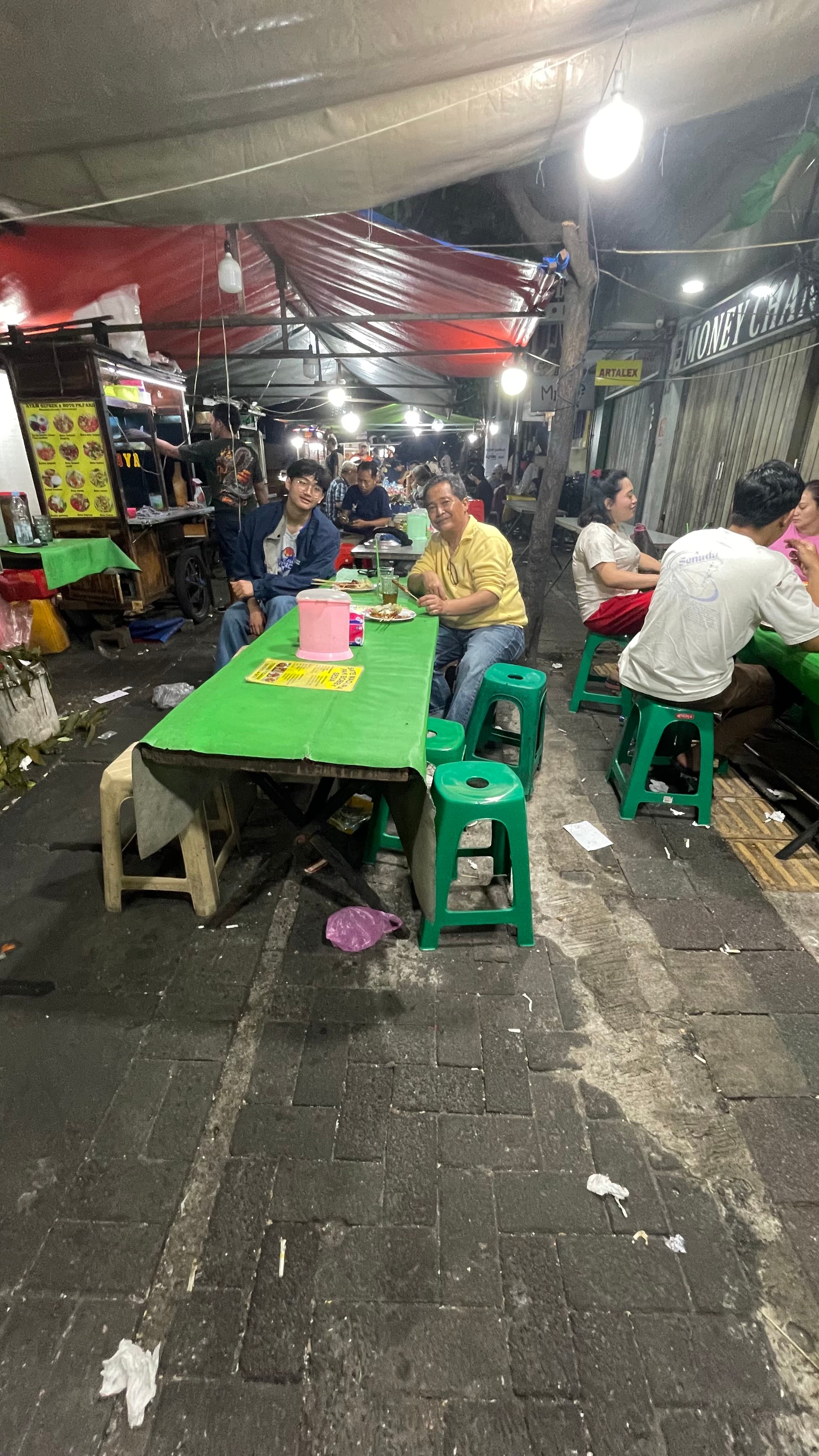 Ihsan Tjahyono with his father at a street food stall at night