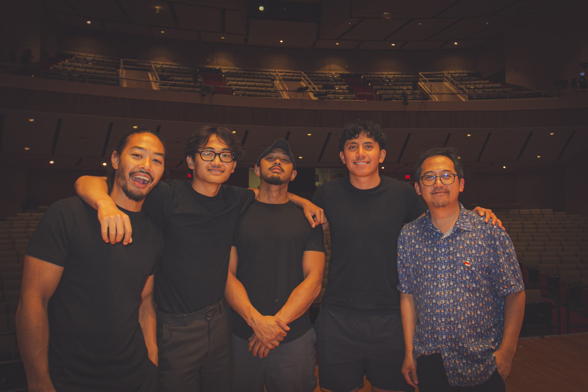 Ihsan Tjahyono with four others on a theatre stage