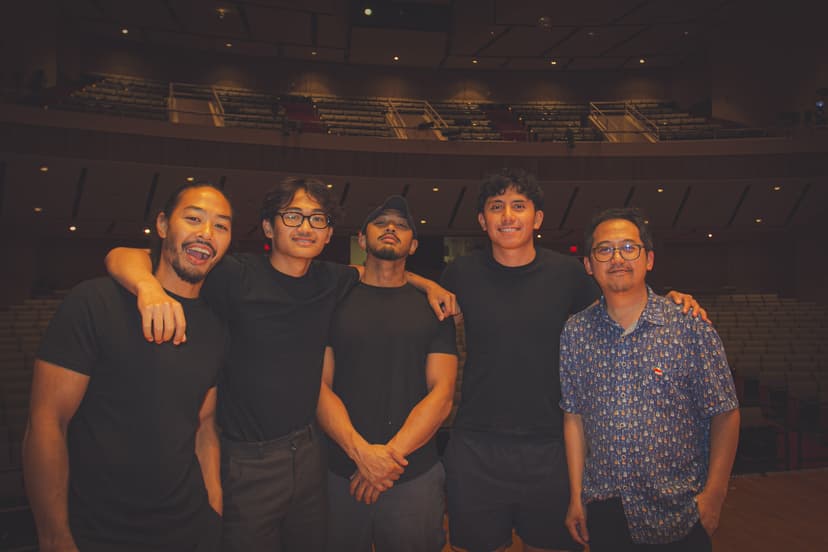 Ihsan Tjahyono with four others on a theatre stage